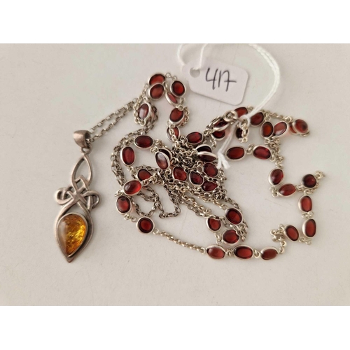 417 - An amber  silver pendant necklace together with an amber silver bead necklace