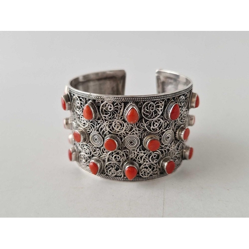 431 - A tribal silver wide cuff bangle set with coral