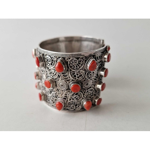 431 - A tribal silver wide cuff bangle set with coral