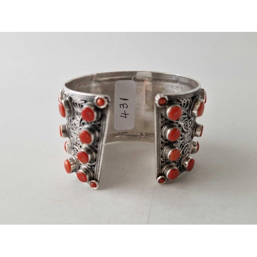 431 - A tribal silver wide cuff bangle set with coral