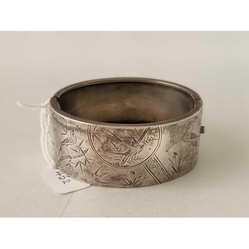 452 - A engraved silver bangle with bird decoration 30 gms