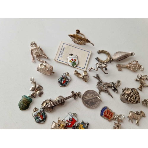 512 - A quantity of assorted silver charms, 61 g