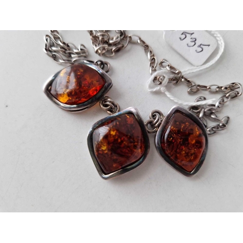 535 - A silver amber necklace designed as three silver lozenge amber set drops