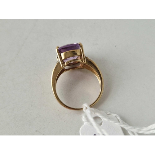 580 - A amethyst ring with diamond shoulders 9ct size N 5 gms