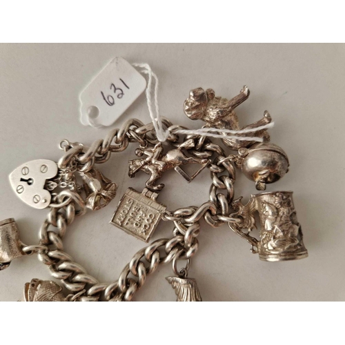 631 - A heavy silver charm bracelet 7 inch 96 gms