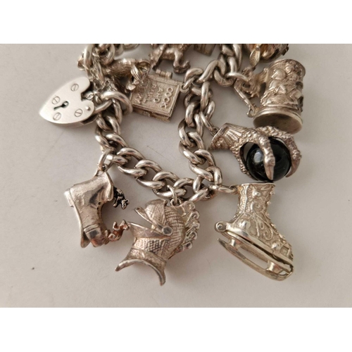 631 - A heavy silver charm bracelet 7 inch 96 gms