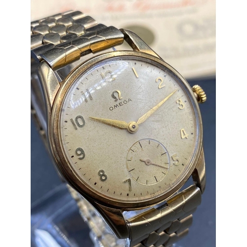 693 - A gents Omega wrist watch with seconds dial with papers