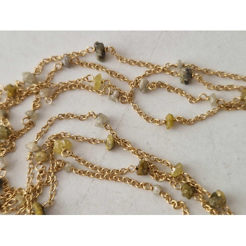 77 - A long fancy 18ct gold chain set with rough diamonds  5g