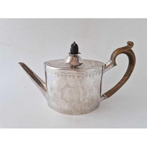 834 - A George III oval tea pot with engraved rims and carved pineapple finial to cover, 10.5