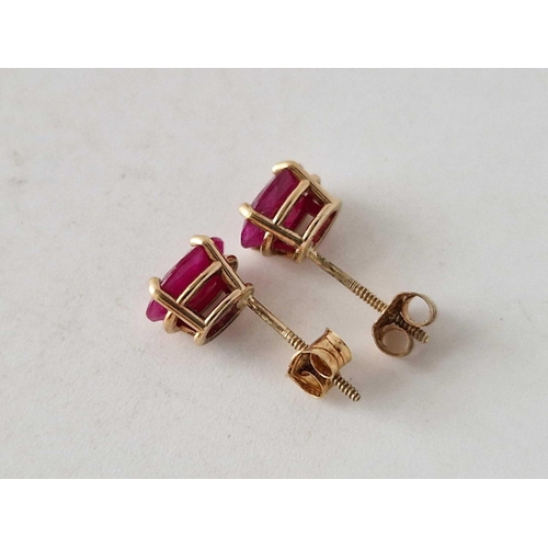 85 - A pair of ruby stud earrings 14ct gold