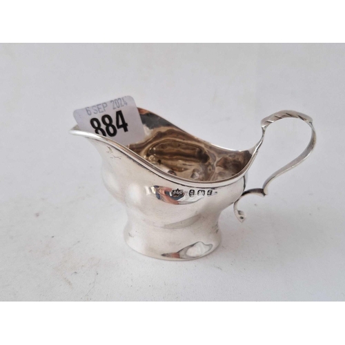 884 - A cream jug with leaf capped scroll handle, 4 inches wide, Birmingham 1904, 45 g