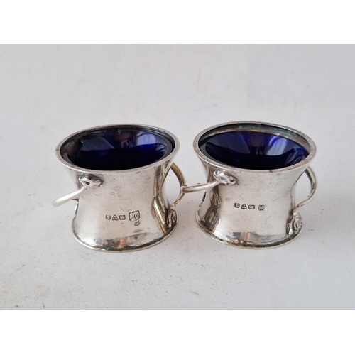 885 - A pair of Art Nouveau salts with stylish handles, two inches diameter, Chester 1921, 60 g excluding ... 