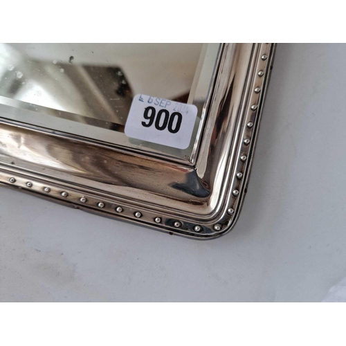 900 - An oblong mirror with decorated rim, 10.5