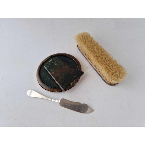 907 - A circular photo frame, a clothes brush and a sterling butter knife