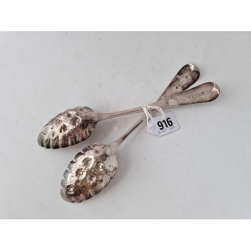 916 - A heavy pair of Georgian Berry spoons with chased decoration, London 1823 by script HI?, 148g