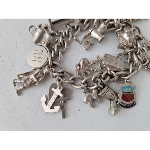 939 - A silver charm bracelet, 55 g