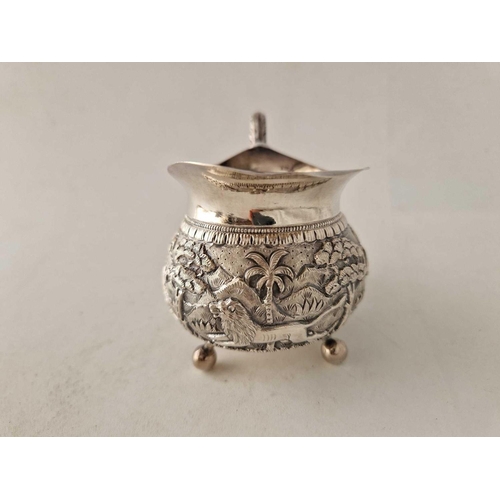 976 - An eastern silver cream jug with well chased band, by CGK (950 standard), 120 g