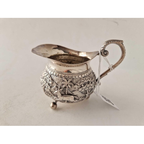 976 - An eastern silver cream jug with well chased band, by CGK (950 standard), 120 g