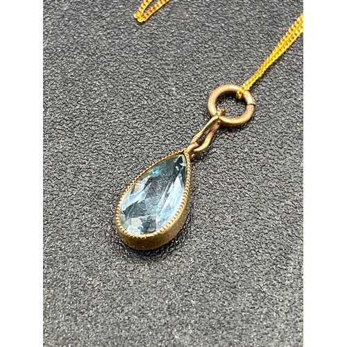 62 - A good aquamarine pendant drop in high carat gold on gold chain