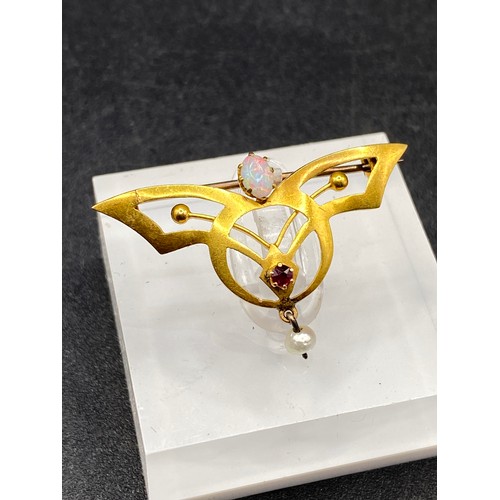 61 - An attractive Arts and Crafts stylised fine opal and ruby brooch with pearl drop