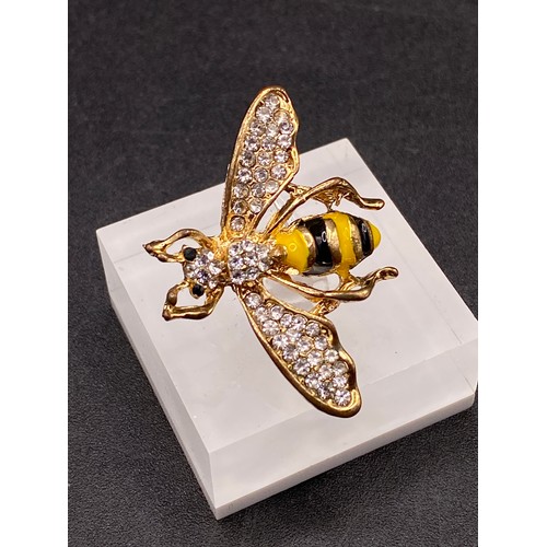 63 - A pretty gem set and enamel bee brooch with gem set eyes