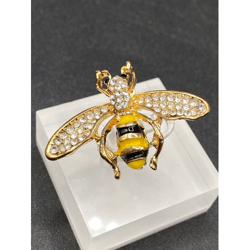 63 - A pretty gem set and enamel bee brooch with gem set eyes