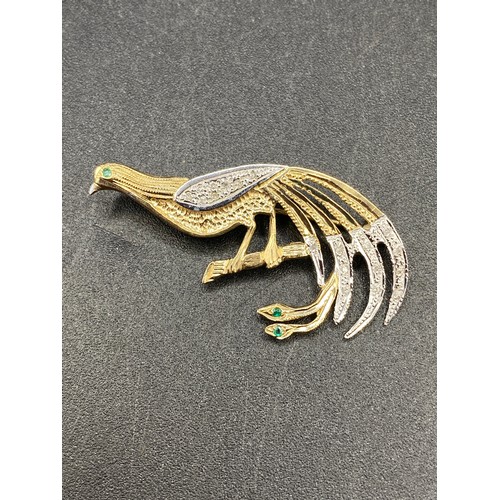 64 - A vintage two colour gold diamond peacock brooch with emerald eye, 9ct