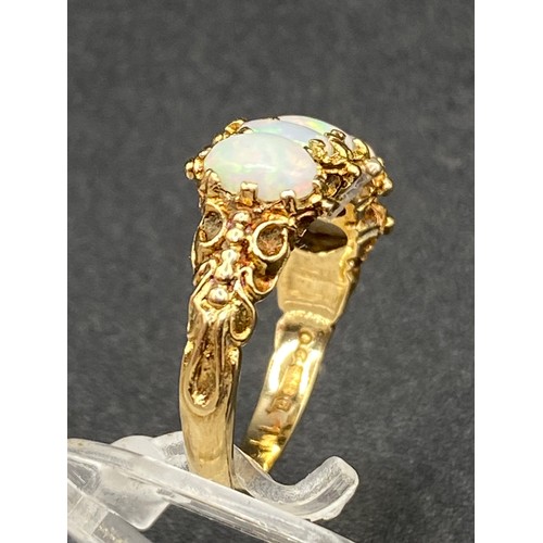 67 - A vintage five stone opal ring, the fiery shows multi coloured flashes Size N