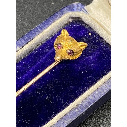 231 - An antique carved Foxs Mask top stick pin with cabochon ruby eye, 15ct, screw top and Box