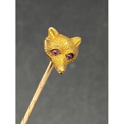 231 - An antique carved Foxs Mask top stick pin with cabochon ruby eye, 15ct, screw top and Box