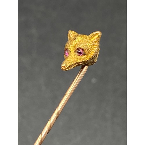 231 - An antique carved Foxs Mask top stick pin with cabochon ruby eye, 15ct, screw top and Box