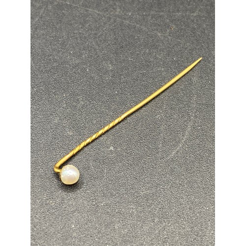 335 - A Victorian stick pin mounted with a natural pearl 15ct gold