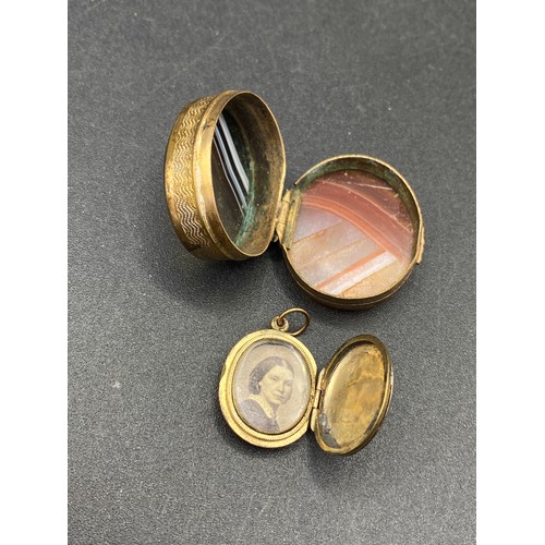 163 - A rolled gold oval picture locket together with a oval agate toped pill boxes and hard stone seal