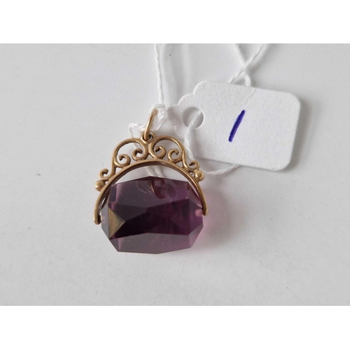 1 - A amethyst coloured revolving seal with gold scroll mount