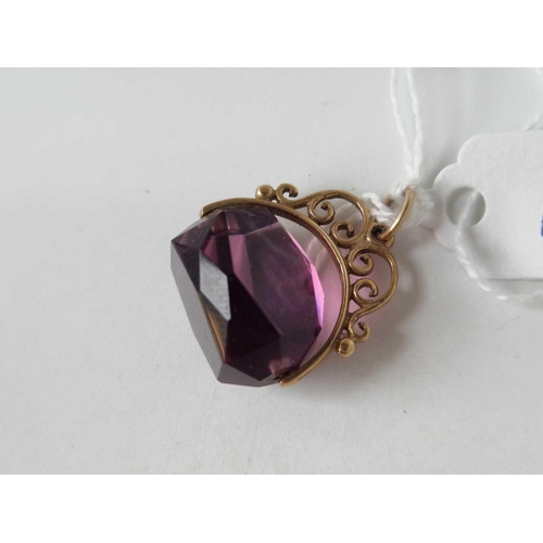 1 - A amethyst coloured revolving seal with gold scroll mount