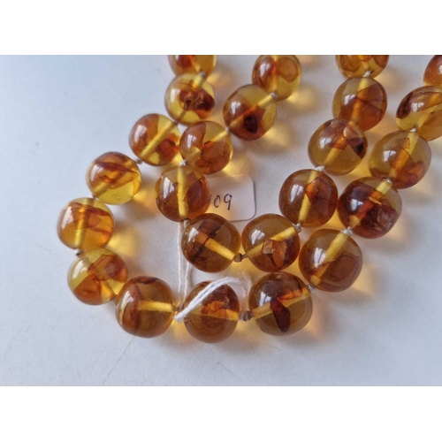 109 - A string of amber beads approx. 15mm diameter 24 inch 103 gms