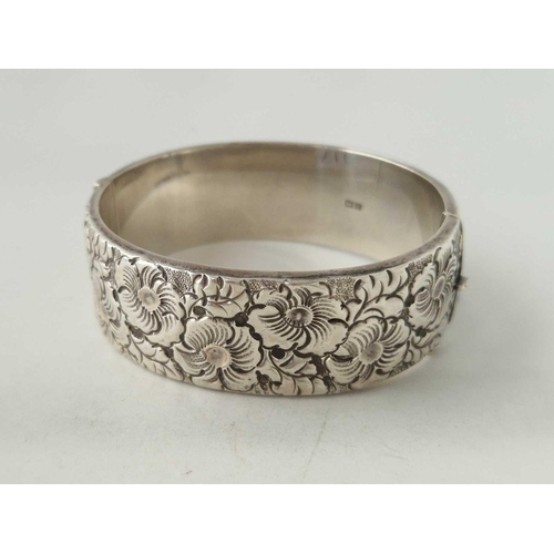 117 - A solid silver heavy gauge wide floral bangle 35 gms