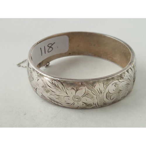 118 - A solid silver heavy gauge wide floral bangle 29 gms