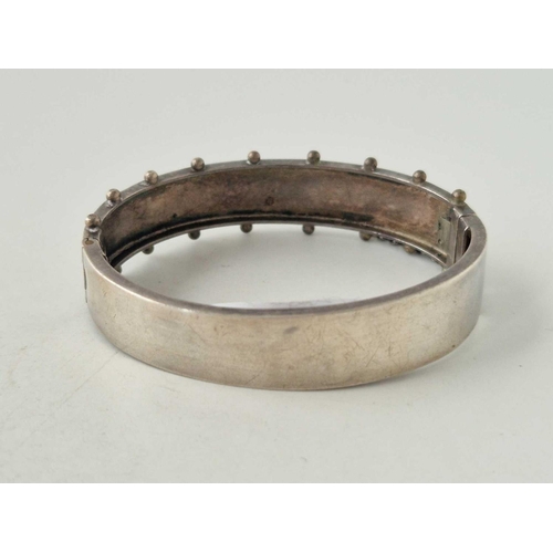 119 - A silver floral design bangle 17 gms