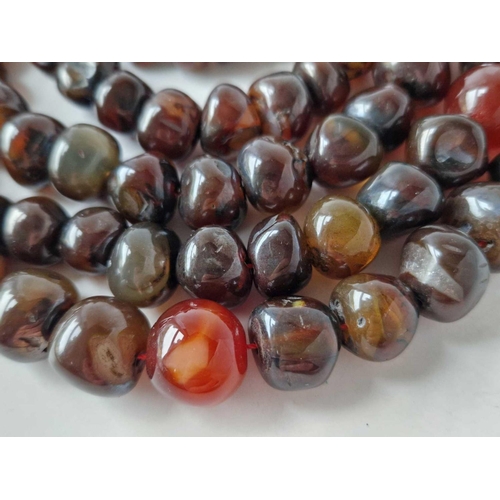 121 - A long string of agate beads 58 inch