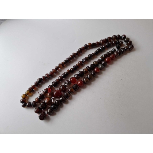 121 - A long string of agate beads 58 inch