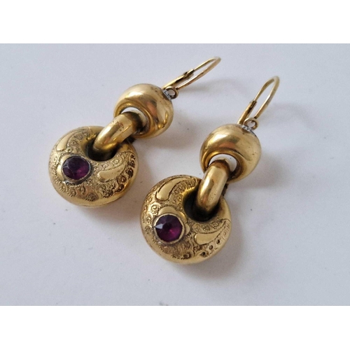 132 - A pair of antique gold cased drop earrings set with red stones