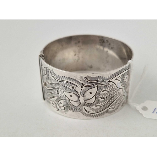 152 - A vintage silver bangle with butterfly and fern decoration 56 gms