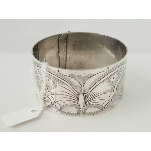 152 - A vintage silver bangle with butterfly and fern decoration 56 gms