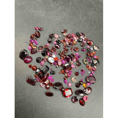 172 - A tub of assorted red gem stones ex jewellers stock