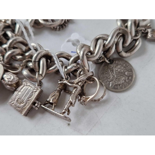 187 - A silver charm bracelet 7 inch 73 gms