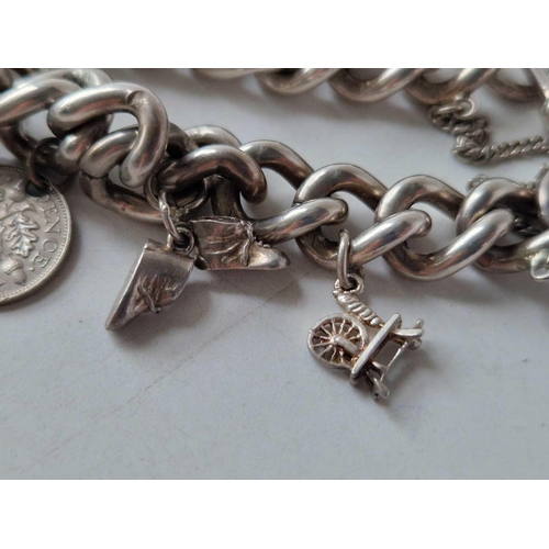 187 - A silver charm bracelet 7 inch 73 gms