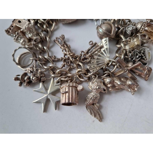 229 - A silver charm bracelet 7 inch 92.8 gms