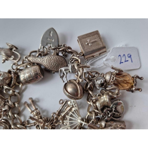 229 - A silver charm bracelet 7 inch 92.8 gms