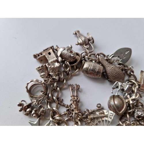 229 - A silver charm bracelet 7 inch 92.8 gms